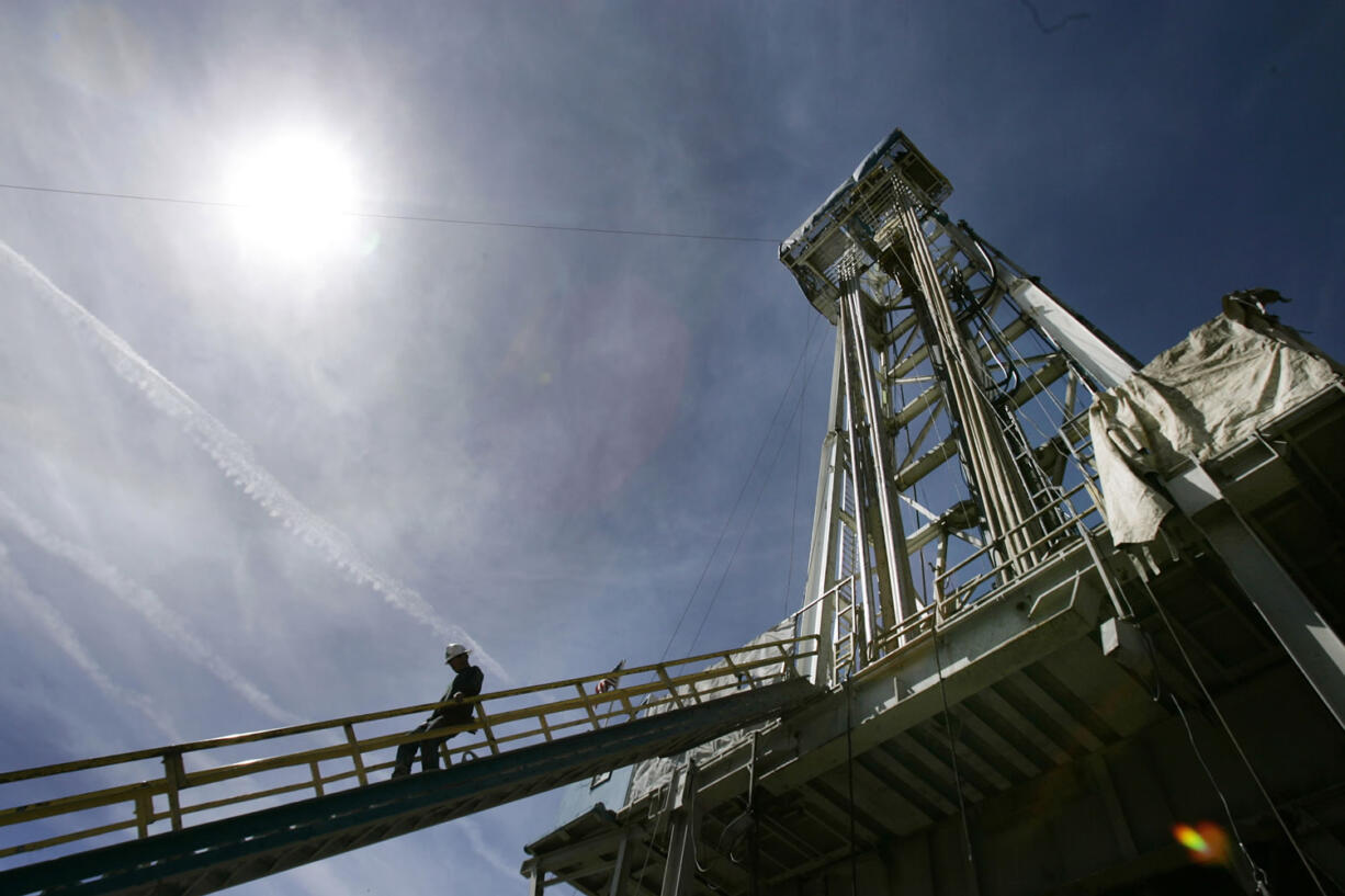 A worker steps down from the drilling platform at Newberry Crater near LaPine, Ore. After pumping more than 20 million gallons of water into the side of the ancient volcano last year, AltaRock Energy Inc.