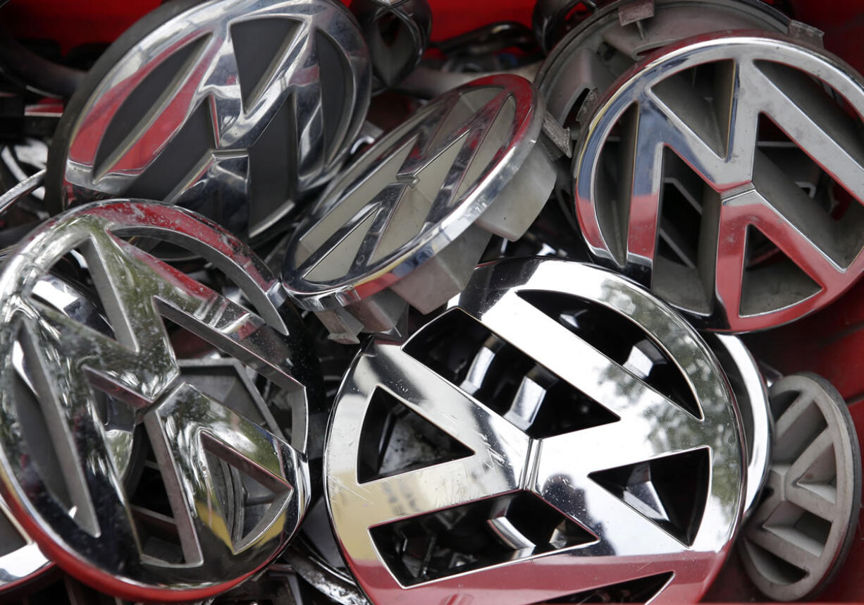 Volkswagen ornaments sit in a box in a scrap yard in Berlin, Germany. Volkswagen said Wednesday that a problem with carbon dioxide emissions is far smaller than initially suspected, with further checks finding &quot;slight discrepancies&quot; in only a few models and no evidence of illegal changes to fuel consumption and emissions figures.