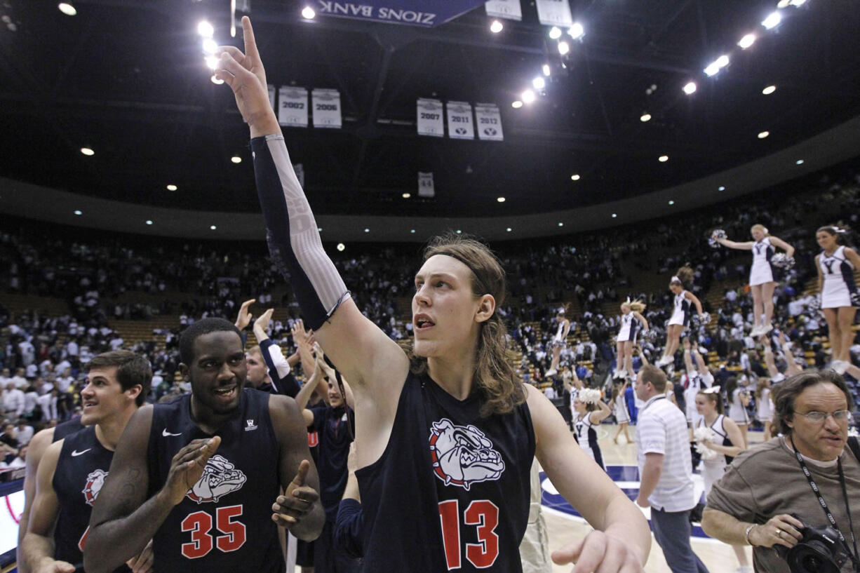 Gonzaga's Kelly Olynyk (13) and teammate Sam Dower (35) celebrate their 70-65 victory over Brigham Young on Thursday in Provo, Utah.