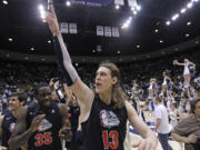 Gonzaga's Kelly Olynyk (13) and teammate Sam Dower (35) celebrate their 70-65 victory over Brigham Young on Thursday in Provo, Utah.