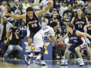 Gonzaga's David Stockton (11) knocks the ball away from San Diego's Christopher Anderson as Gonzaga's Elias Harris blocks during the second half Saturday.