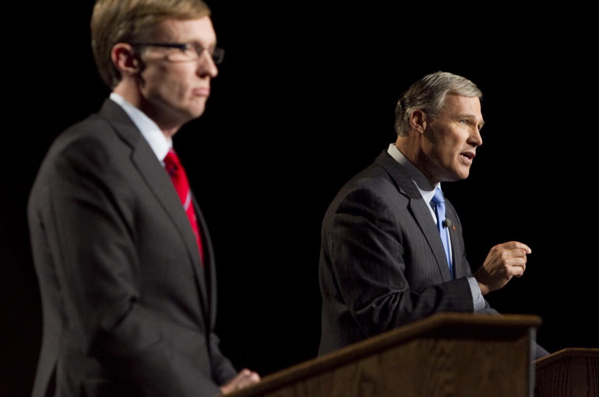 Washington state Republican gubernatorial candidate Rob McKenna, left, listens while Democratic challenger Jay Inslee speaks during their debate Tuesday in Yakima.