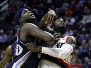 Memphis Grizzlies forward Zach Randolph, left, and Portland Trail Blazers forward J.J. Hickson battle for position under the basket for a rebound during the second half Wednesday.