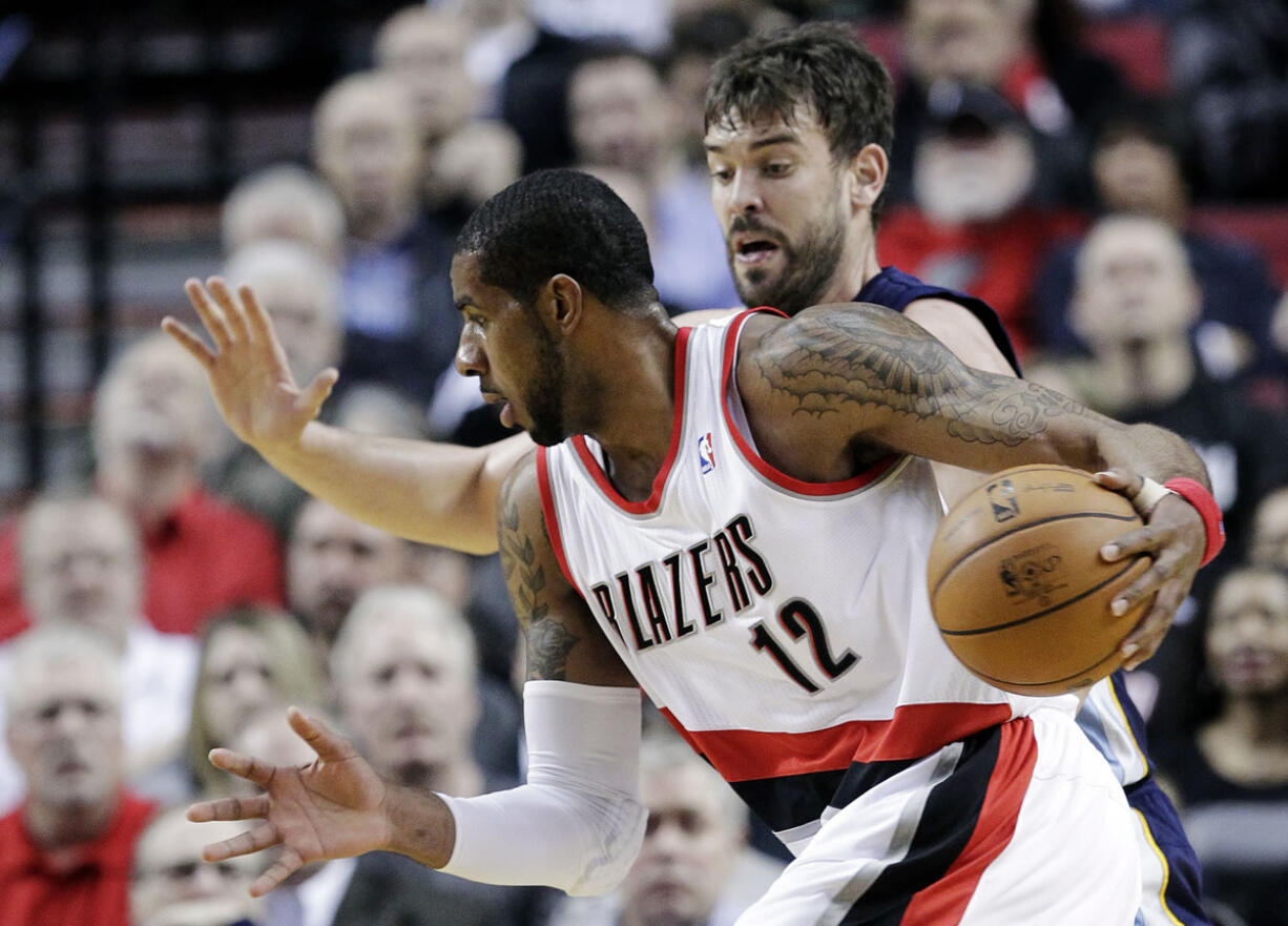 Don Ryan/The Associated Press
LaMarcus Aldridge (12), drives past Memphis' Marc Gasol.