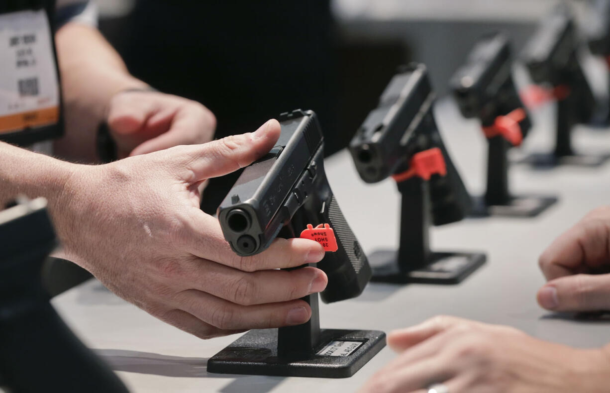 A Glock representative explains features of the Glock 37 Gen 4 .45 caliber pistol at the 35th annual SHOT Show in Las Vegas.