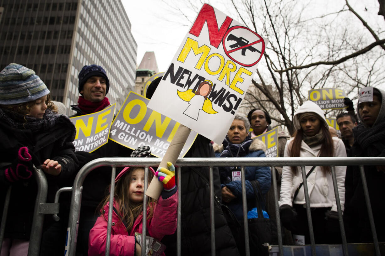 Emma Clyman, 5, of Manhattan, holds a sign that reads &quot;No More Newtowns&quot; outside city hall park during the One Million Moms for Gun Control Rally in New York.