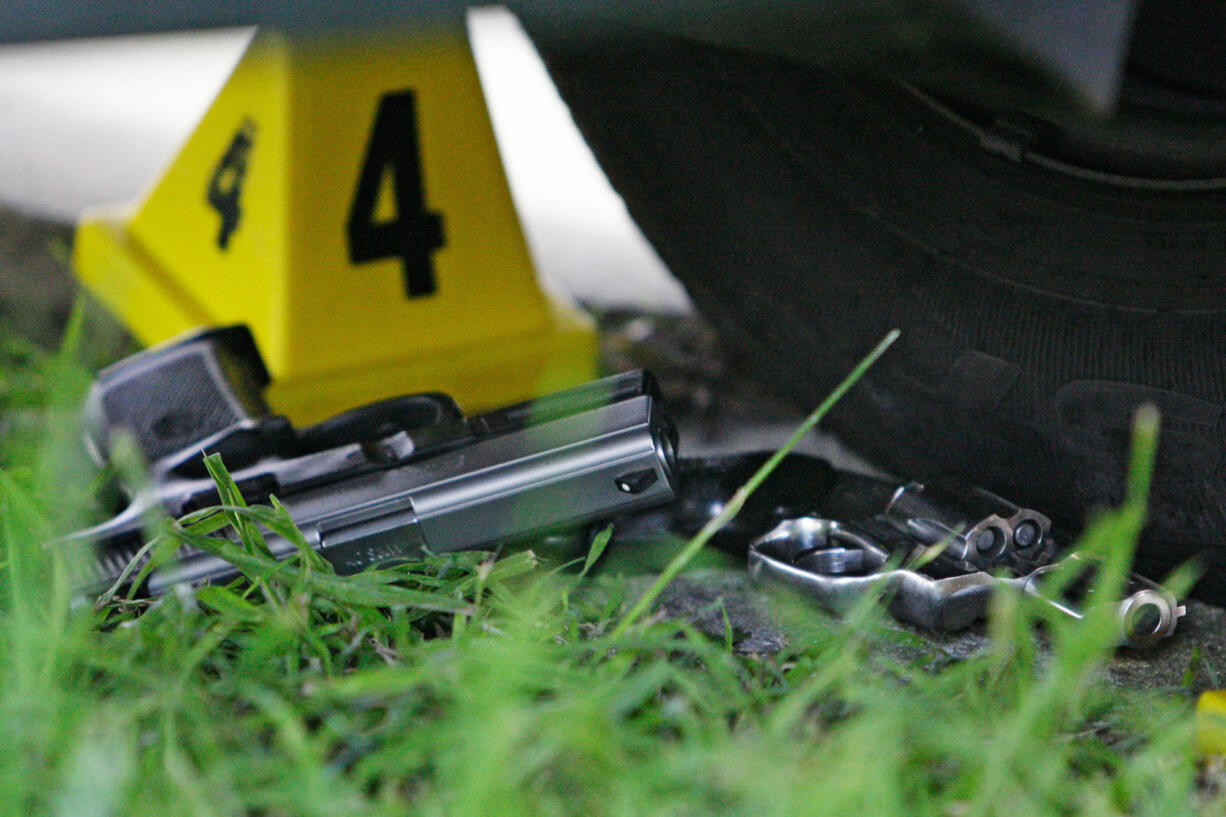 Two guns lie at the scene where five people were shot and two suspects were taken into custody along the Mardi Gras parade route in New Orleans in 2009.