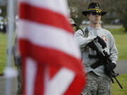 Ryan Brooks of Shelton holds his AR-15 rifle as he attends a gun rights rally Friday at the Capitol in Olympia.