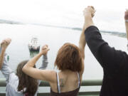 Reanna Lingle, 9, from left, Ashley Lingle, 11, Melissa Parrish and Ralph Stevens join hands on the I-5 bridge for the annual Hands Across the Bridge event, celebrating freedom from addiction, Monday, September 1, 2008.