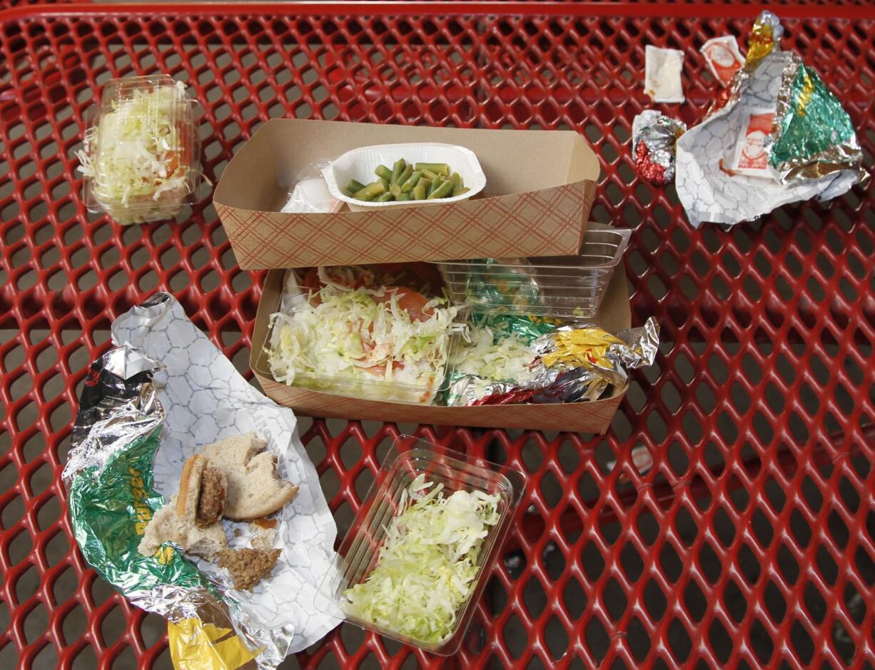 Vegetables left over by students sit on cafeteria trays at the Roosevelt High School in Los Angeles.