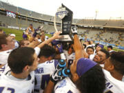 Washington players celebrate their 44-31 victory over Southern Mississippi following the Heart of Dallas Bowl NCAA college football game, Saturday, Dec. 26, 2015, in Dallas.