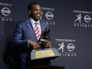 Alabama's Derrick Henry poses for photos after winning the Heisman Trophy, Saturday, Dec. 12, 2015, in New York.