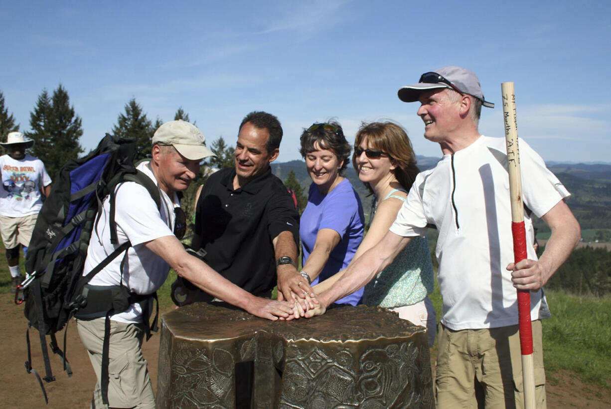 Mike Hawley, right, celebrates his hike to the top of Mount Pisgah near Eugene, Ore., on April 27. With Hawley are the four people he was hiking with Sept.