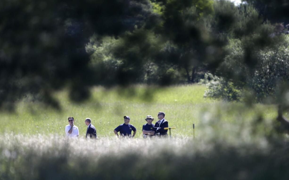 Investigators look over the scene in Oakland Township, Mich., on Monday where officials search for the remains of Teamsters union president Jimmy Hoffa who disappeared from a Detroit-area restaurant in 1975.