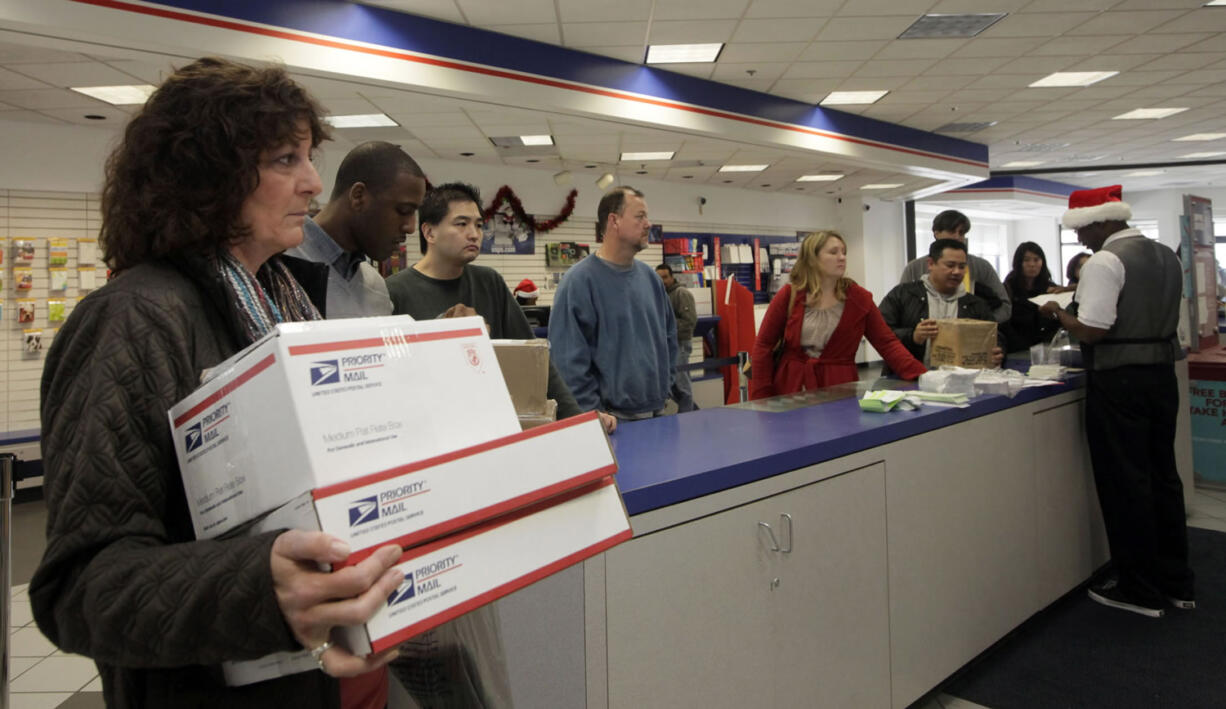 Nick Ut/Associated Press files
People in wait in line in 2011 at the U.S. Postal Service Airport station in Los Angeles. Emboldened by rapid growth in e-commerce shipping, the cash-strapped U.S. Postal Service is moving aggressively this holiday season to start a premium service for the Internet shopper by offering same-day package delivery.