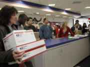 Nick Ut/Associated Press files
People in wait in line in 2011 at the U.S. Postal Service Airport station in Los Angeles. Emboldened by rapid growth in e-commerce shipping, the cash-strapped U.S. Postal Service is moving aggressively this holiday season to start a premium service for the Internet shopper by offering same-day package delivery.