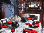 Photos by Sarah Dorio/Associated Press
Bare branches, spray-painted black and secured in vases with gravel, floral foam and a layer of moss make a stunning and inexpensive Halloween centerpiece created by designer Brian Patrick Flynn for HGTV.com.