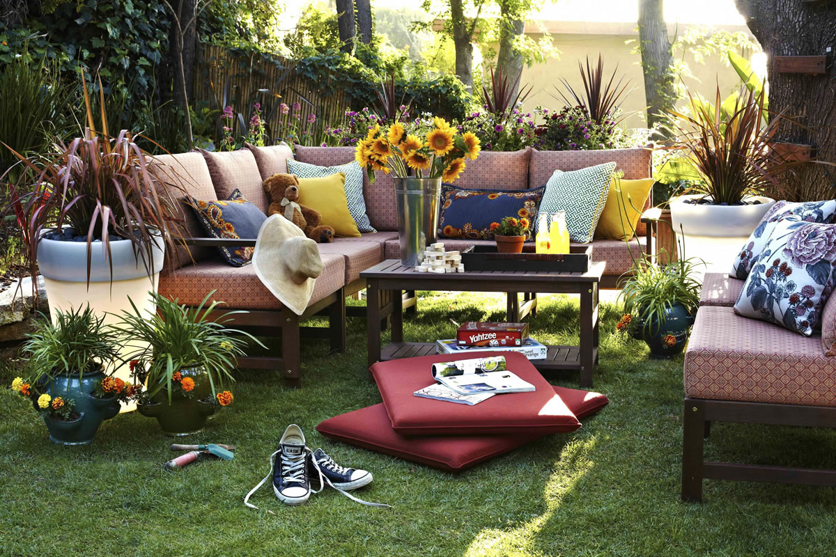 Designer Brian Patrick Flynn added light-up plastic planters to an outdoor family room to give it nighttime use.