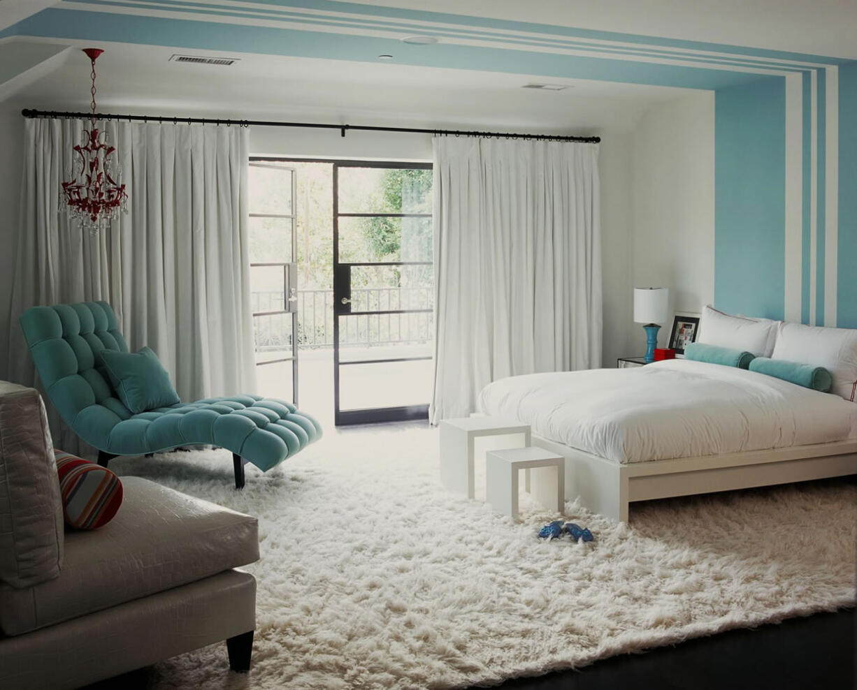 This bedroom designed by Betsy Burnham features walls of pure white and frosty blue complemented by a fluffy snow-white flokati rug.