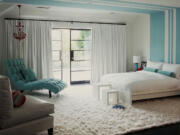 This bedroom designed by Betsy Burnham features walls of pure white and frosty blue complemented by a fluffy snow-white flokati rug.