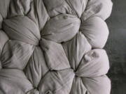 A detail of former interior designer Lynn Cimino's original Twist mattress design -- components include cotton covers and buckwheat hulls that you self-assemble by filling the covers with the hulls and twisting and tying.