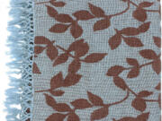 A soft blue with leaf pattern throw.