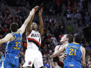 Portland's Damian Lillard (0) shoots the game-winning three-point shot at the buzzer Sunday as New Orleans' Ryan Anderson (33) tries to defend.