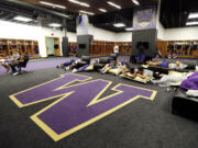 Players lounge in the home locker room at the newly renovated Husky Stadium.