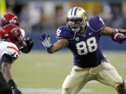 FILE - In this Sept. 1, 2012 file photo, Washington's Austin Seferian-Jenkins (88) defends himself against San Diego State's Josh Wade after a pass reception in the first half of an NCAA college football game in Seattle. Seferian-Jenkins changed his original plea and has pleaded guilty to a charge of driving under the influence stemming from his arrest after crashing his car in March.  Seferian-Jenkins made the guilty plea in Seattle Municipal Court on Monday morning, July 15, 2013, before Judge Fred Bonner.