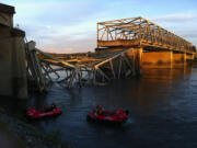 A portion of the Interstate 5 bridge is submerged after it collapsed into the Skagit River dumping vehicles and people into the water in Mount Vernon on Thursday.