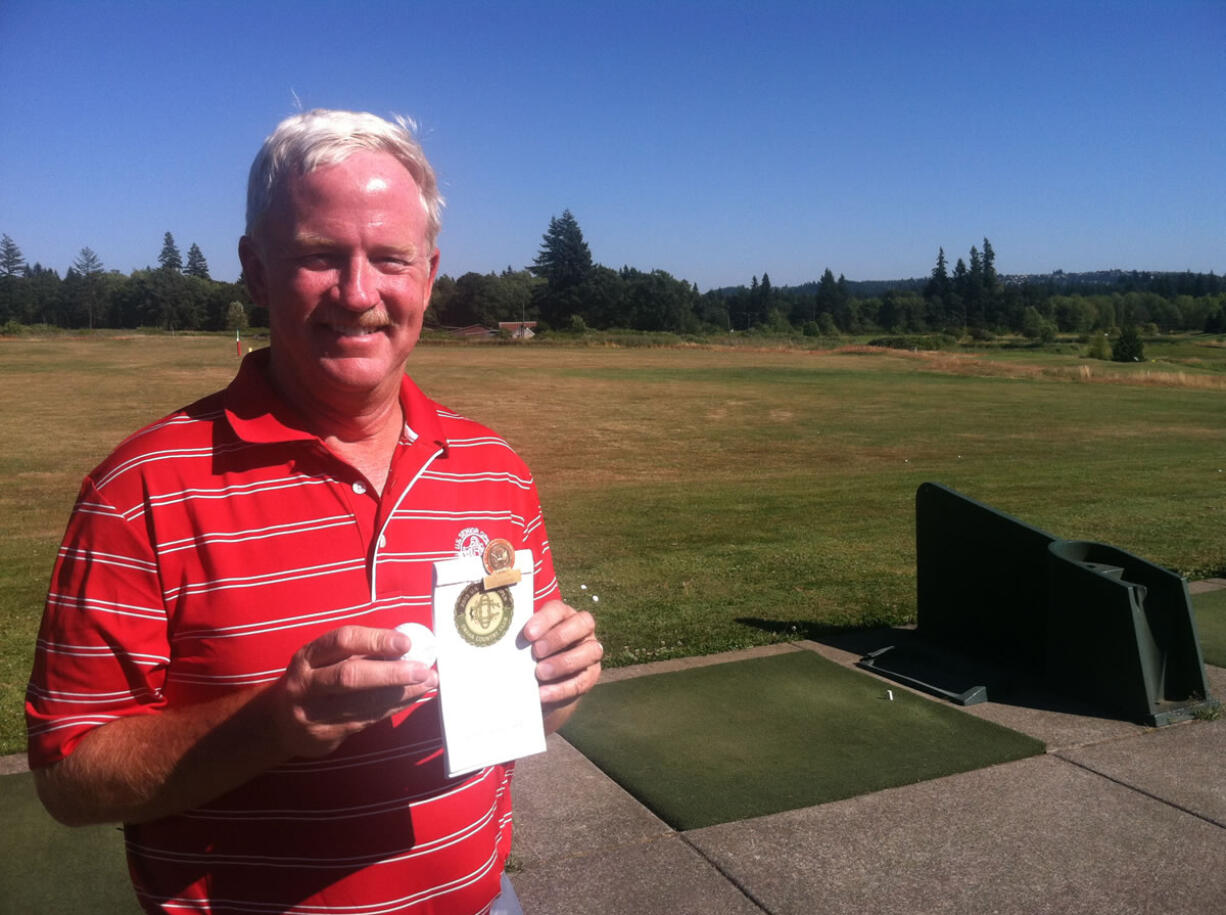 Kevin Coombs stands at the driving range at Green Mountain Golf Course on Monday. He is holding the golf ball and yardage book he used while shooting a 1-under par 69 on June 11 at the U.S.