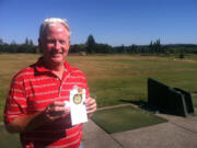 Kevin Coombs stands at the driving range at Green Mountain Golf Course on Monday. He is holding the golf ball and yardage book he used while shooting a 1-under par 69 on June 11 at the U.S.