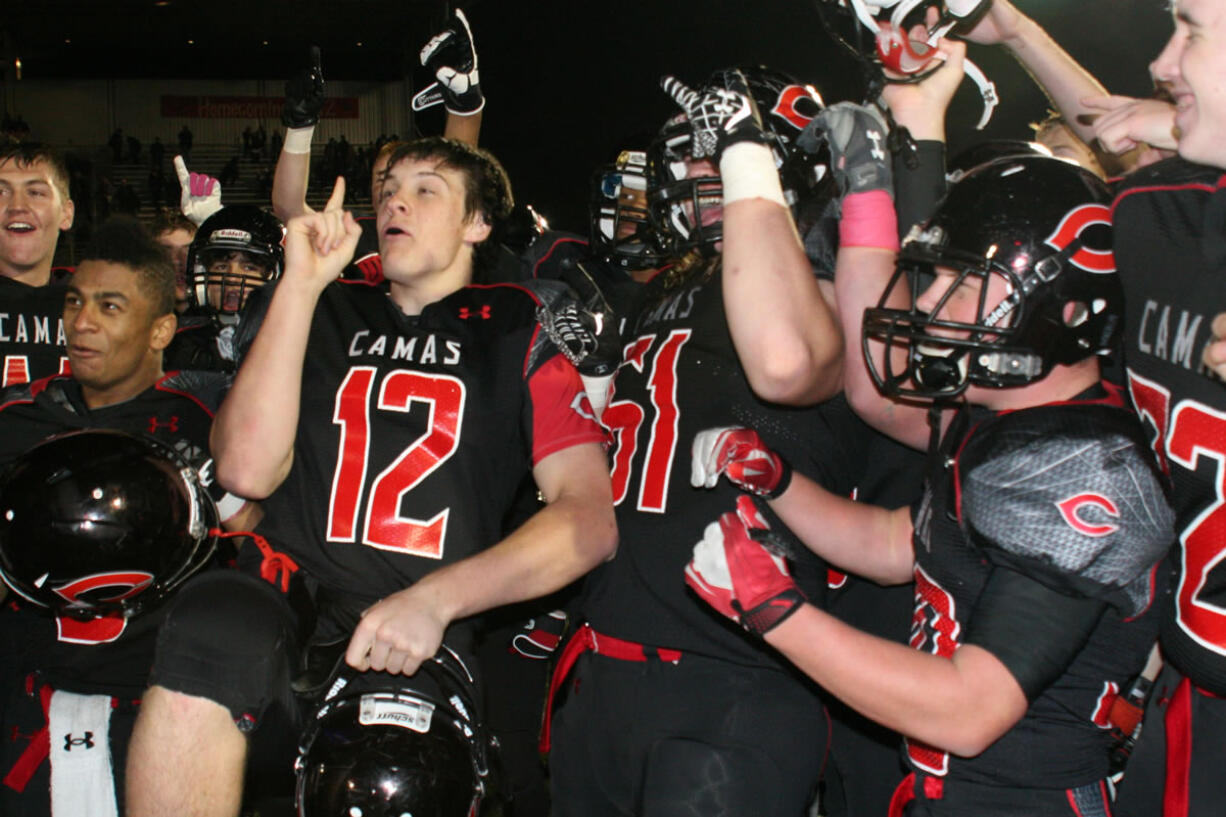 The Camas High School football players celebrate after going undefeated in their first year in the 4A Greater St.