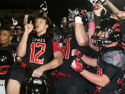 The Camas High School football players celebrate after going undefeated in their first year in the 4A Greater St.