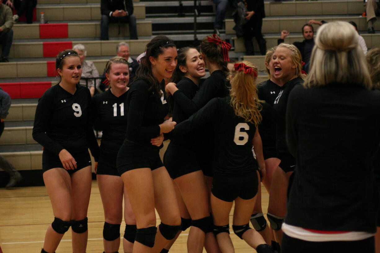 The Papermakers go crazy after beating Union in the fifth set for the 4A district volleyball championship Wednesday, at Camas High School.