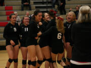 The Papermakers go crazy after beating Union in the fifth set for the 4A district volleyball championship Wednesday, at Camas High School.