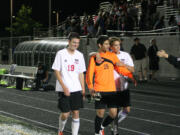 Camas soccer seniors Houston Taie (right) and Matt Rose (left) celebrate with goalkeeper Sharif Batroukh (middle) after Batroukh blocked the last shot in a shootout with Skyline Tuesday, at Doc Harris Stadium.