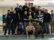 The Camas High School boys swimmers and their coaches celebrate winning the 4A district championship meet Thursday, at Propstra Pool. The Papermakers racked up 459 points.