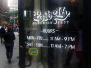 People walk past a Potbelly Sandwich shop in New York.