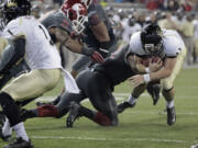 Washington State linebacker linebacker Darryl Monroe, center, on knee, tackles Idaho quarterback Chad Chalich at the 1-yard-line as linebacker Eric Oertel (21) comes in to help Saturday in Pullman.