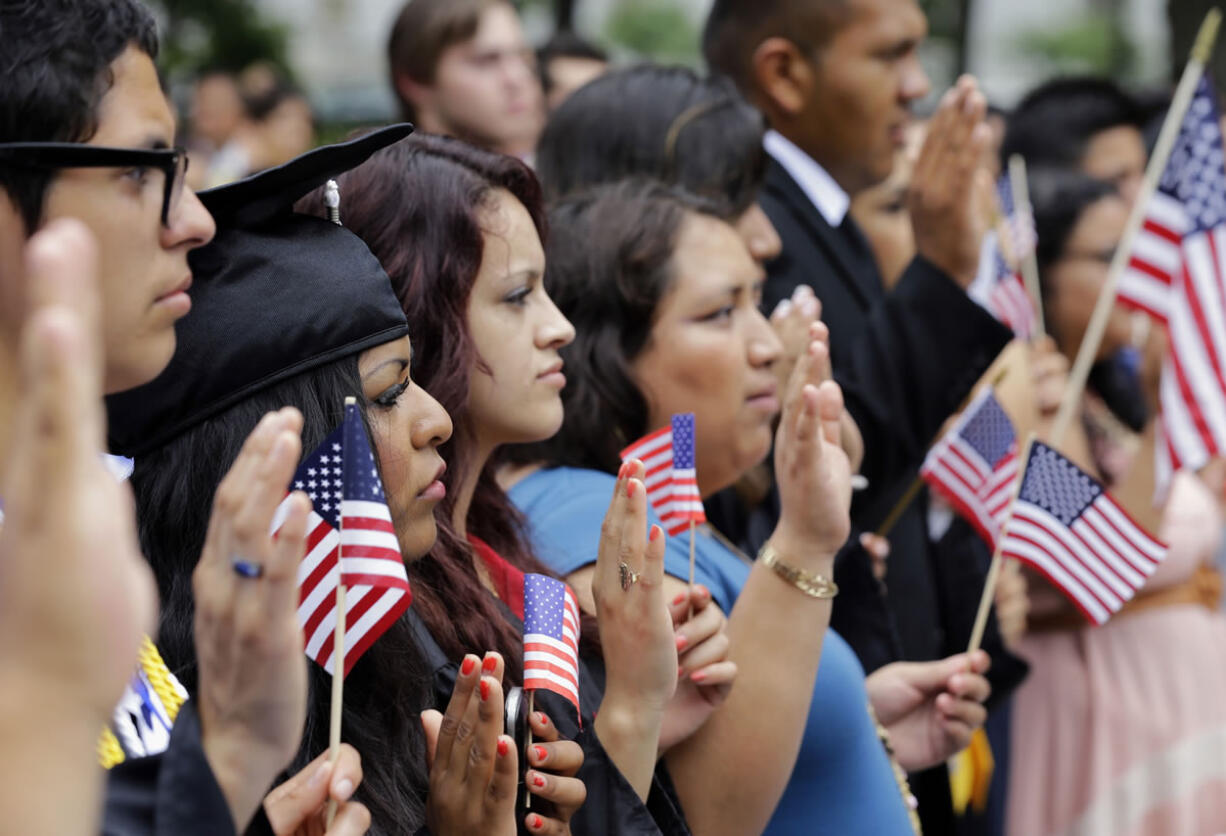 DREAMers (Development, Relief, and Education for Alien Minors) and parents take an oath in a mock citizenship ceremony during a &quot;United we Dream,&quot; rally on Capitol Hill in Washington, Wednesday, July 10, 2013, sending a signal to the House of Representativesi GOP leadership as they go into their meeting that afternoon to discuss immigration reform with their caucus.