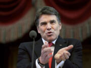 Eric Gay/Associated Press files
Gov. Rick Perry delivers the State of the State address Jan. 29 in the House chambers at the state Capitol in Austin, Texas. Perry is hunting for new businesses to move from California to Texas.