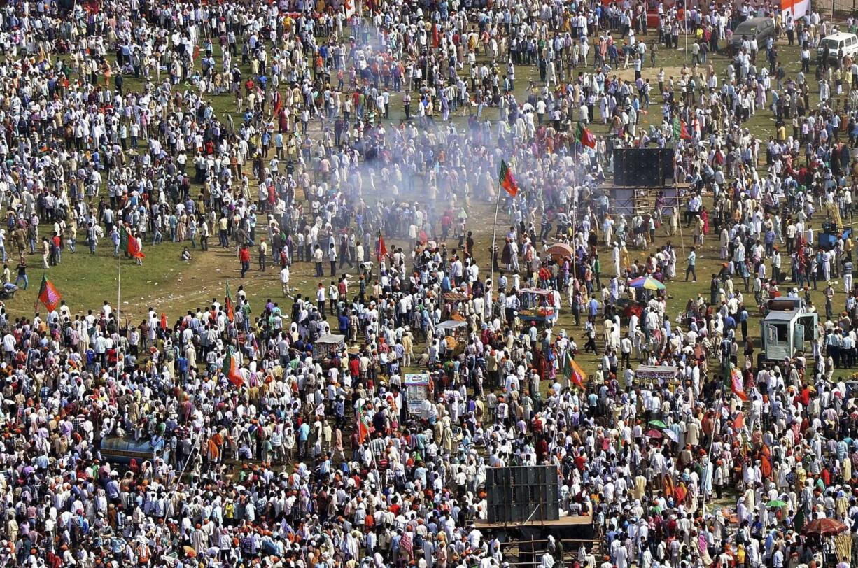 Plumes of gray smoke swirl above the crowd after one of a series of small bombs exploded near the venue of a rally by India's main opposition party in Patna, India, on Sunday.