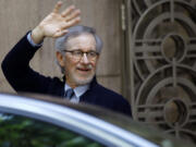 Director Steven Spielberg waves to the media as he leaves Indian Industrialist Anil Ambani's office in Mumbai, India, on Monday.