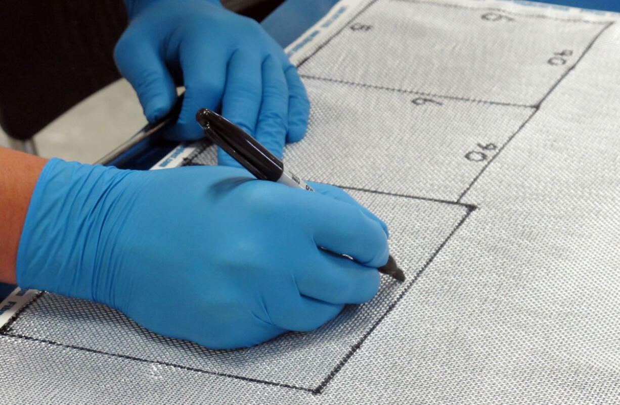 An Airway Heights Corrections Center inmate works on aerospace composites Aug.