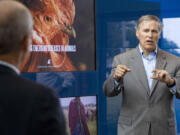 Washington Gov. Jay Inslee, right, asks Tim Baszler a question during a tour of the Paul G.