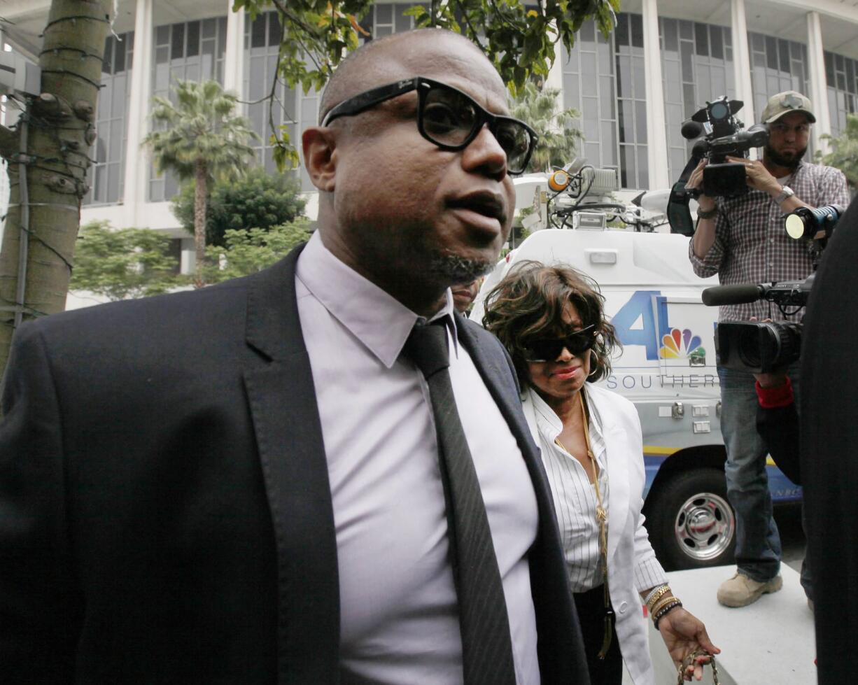 Randy Jackson and Rebbie Jackson, background right, brother and sister of late pop star Michael Jackson, arrive at a courthouse for Katherine Jackson's lawsuit against concert giant AEG Live in Los Angeles on Monday.