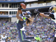 Seattle Seahawks' Sidney Rice, front left, snags the ball in the end zone for a touchdown in front of Jacksonville Jaguars' Josh Evans.