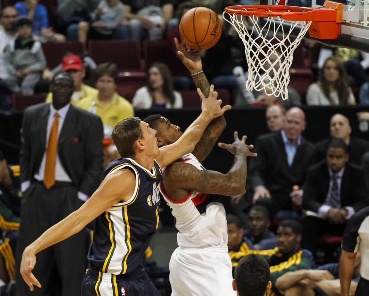 Blazers forward Thomas Robinson shoots past Utah's Andris Biedrins in the second half Friday in Boise, Idaho.