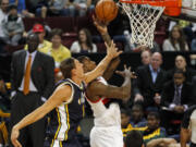 Blazers forward Thomas Robinson shoots past Utah's Andris Biedrins in the second half Friday in Boise, Idaho.